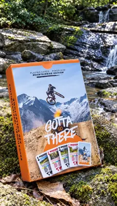 MTB Edition box on a mossy rock beside a creek and waterfall